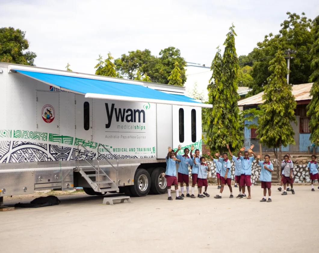 School students beside the dental, medical and training trailer in Port Moresby